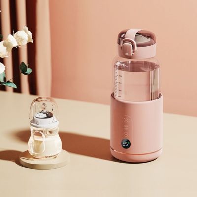 chauffe biberon rose sur table