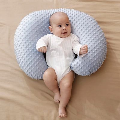 Coussin d'allaitement gris bébé sur le dos souriant
